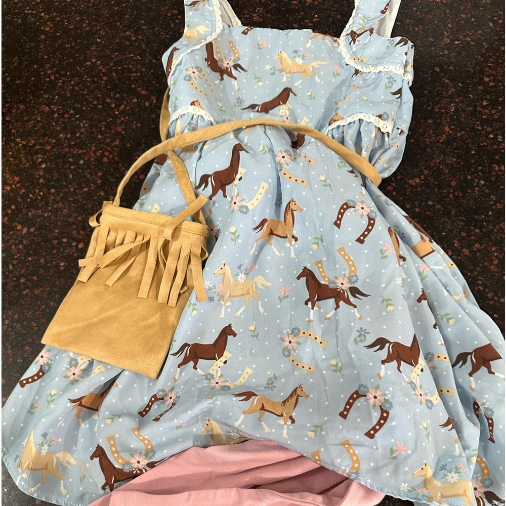 Two little girls outfits with books.